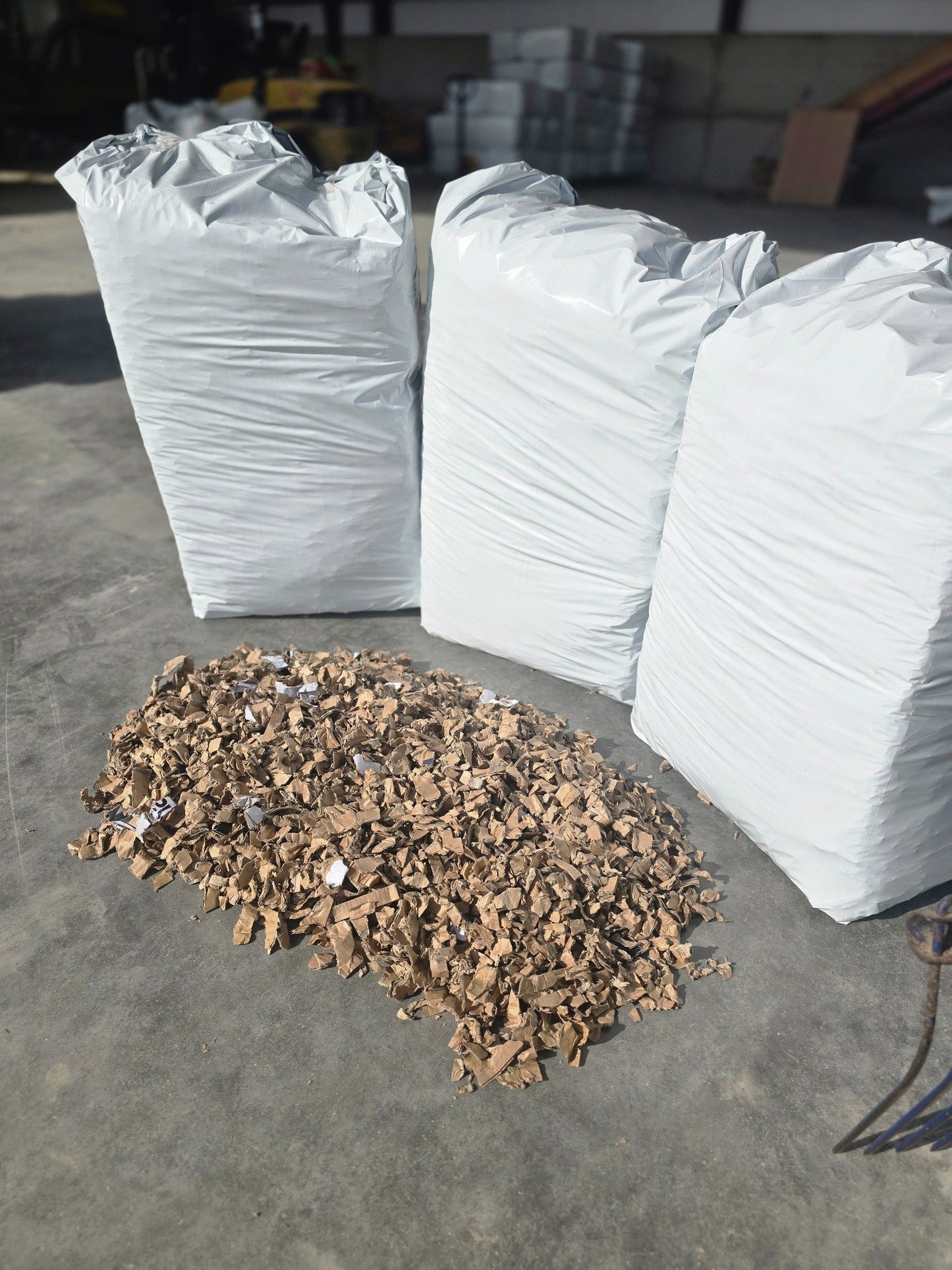 Close-up of ShredEase bedding bales with material spread on the floor