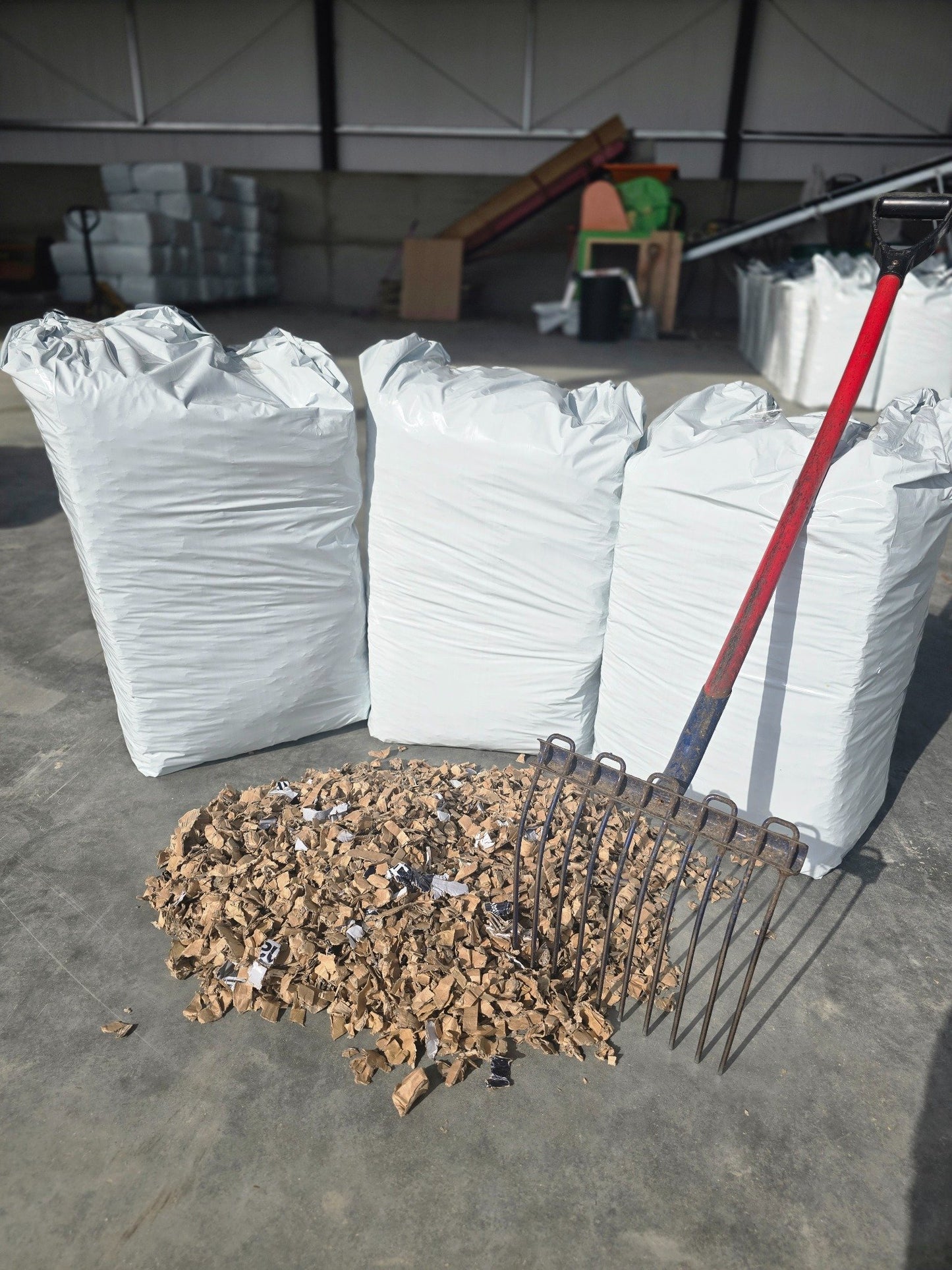 Standard bale display of ShredEase cardboard bedding with mucking out fork upright
