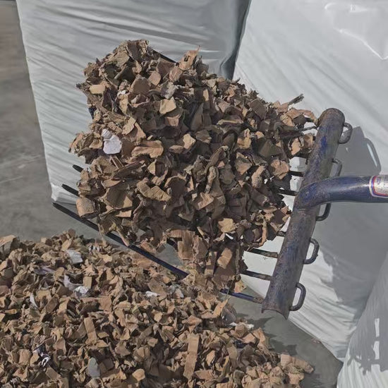 Video showing shredded cardboard pet bedding falling from a mucking out fork to demonstrate texture and flow